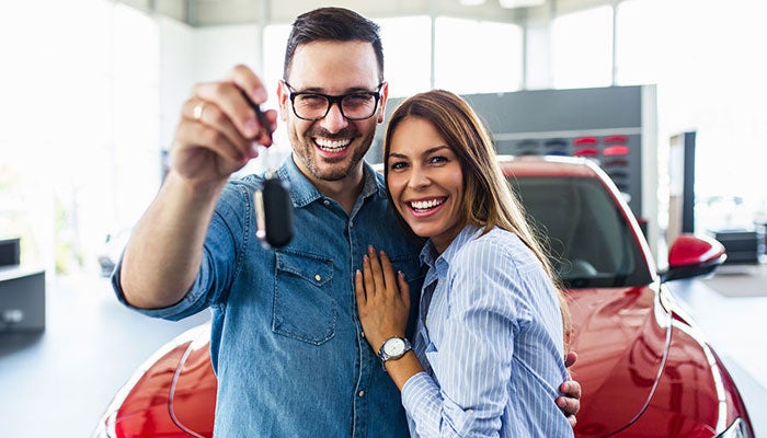 Smiling couple with car keys